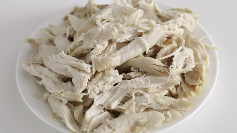 Shredded chicken meat on plate