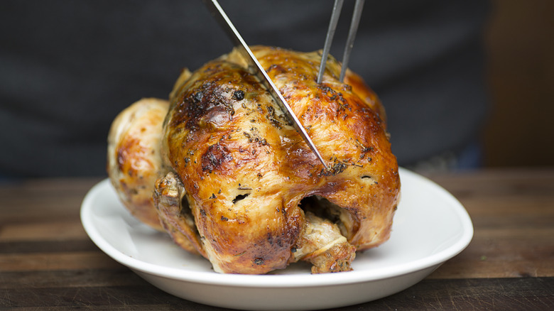 Rotisserie chicken being cut