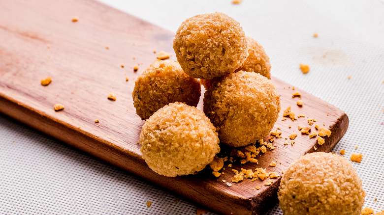 Croquettes stacked on a wooden board