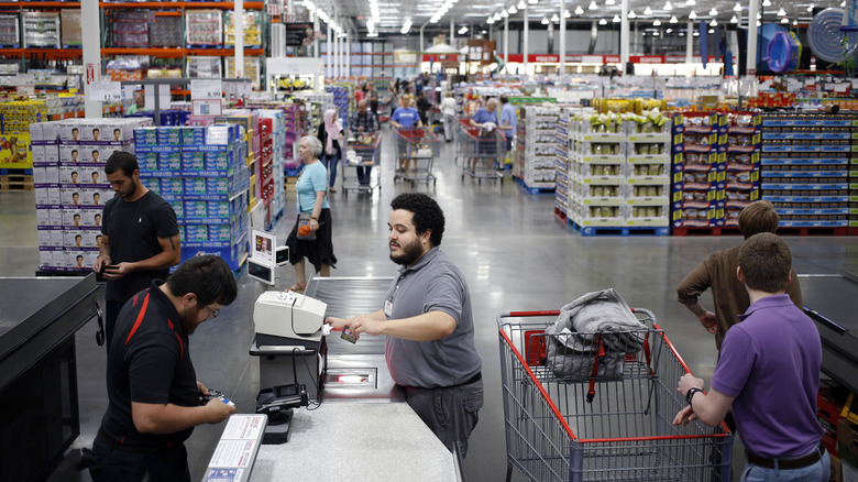 Costco cashier helping customer at checkout