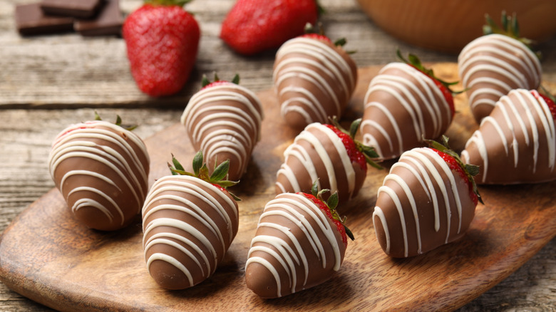 Chocolate covered strawberries on wood board