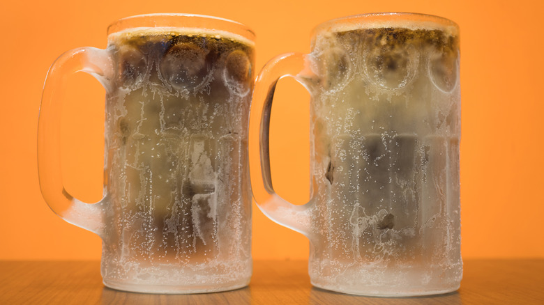 Two frosty mugs of soda