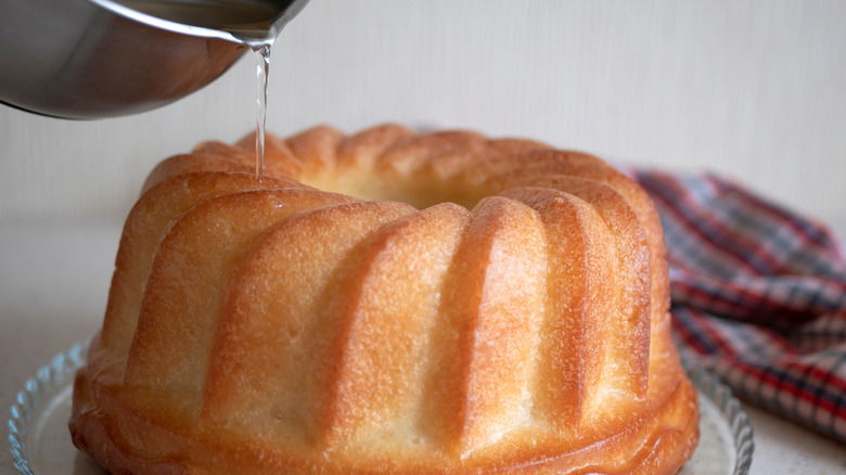 liquid being poured over a Bundt cake