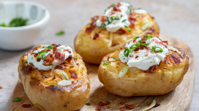 Twice baked potatoes with sour cream, bacon, and scallions