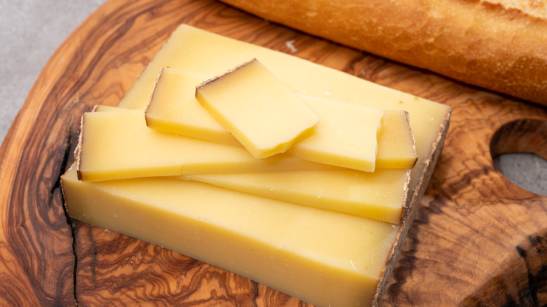 Slices of Comte cheese on a cutting board