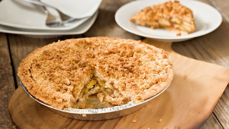 A peach pie on a cutting board