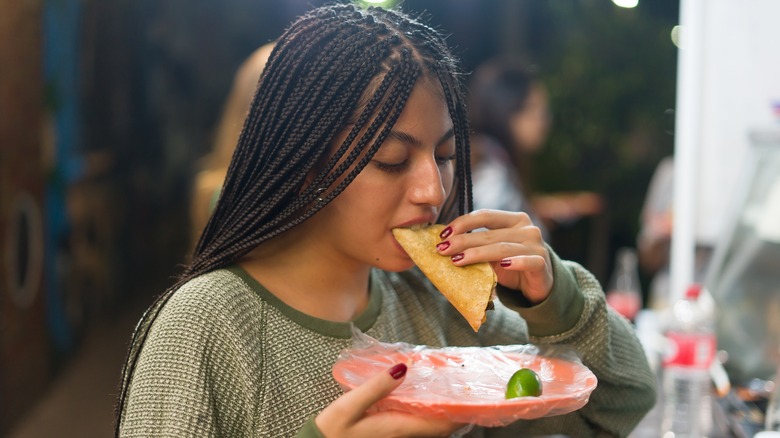 Person eating a taco