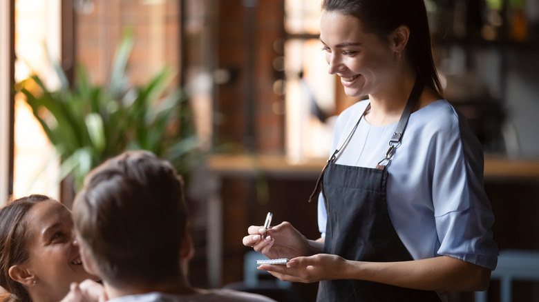 Female server with customers