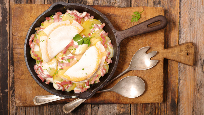 Overhead shot of a tartiflette in a cast iron pan.