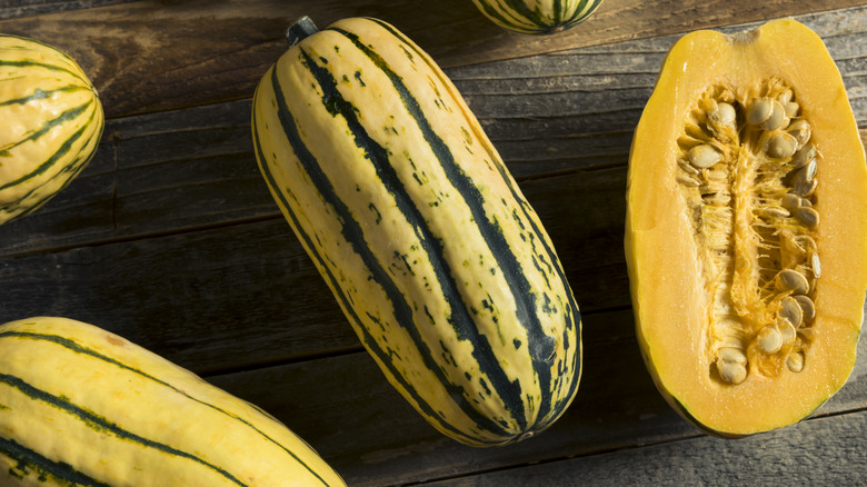 squash cut in half behind wooden background