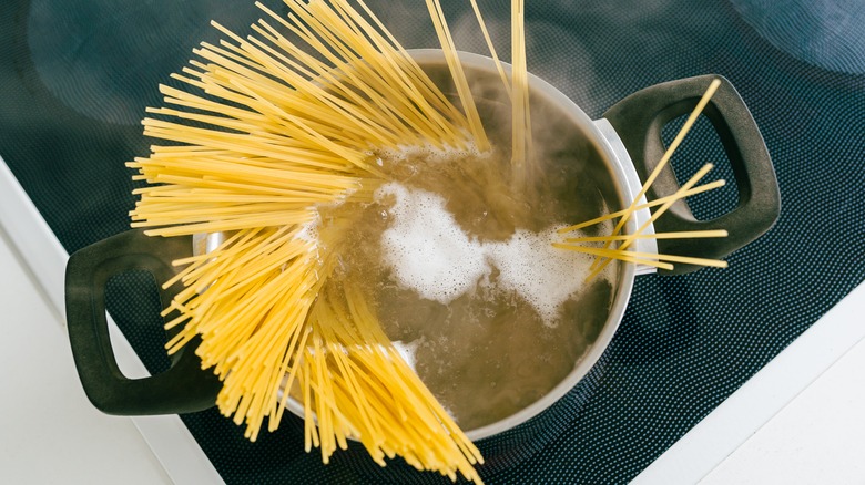 Spaghetti boiling in pot