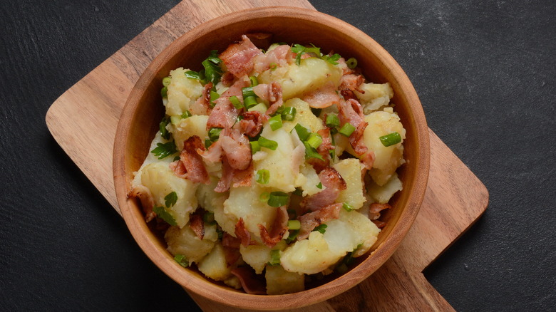 German potato salad topped with bacon