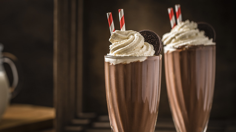 Two chocolate shakes with straws