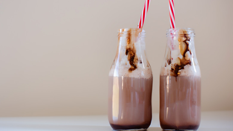 Two bottled shakes with chocolate sauce