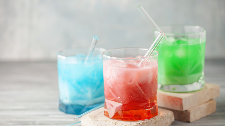 three dirty sodas on grey background