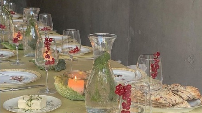 Glasses, plates, and candles on a long table 