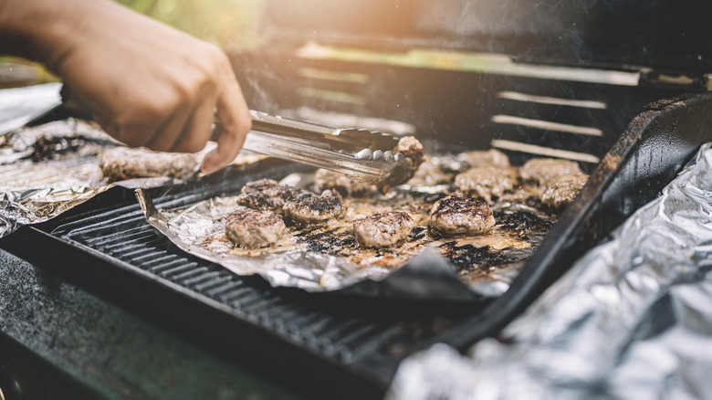 Person grilling on aluminum foil