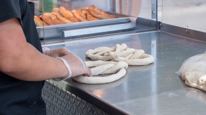 Person making soft pretzels