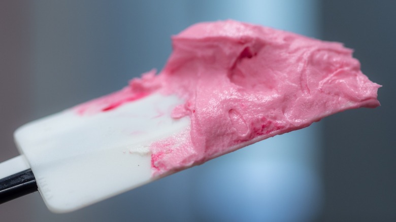 Close-up of pink cake batter on a white spatula