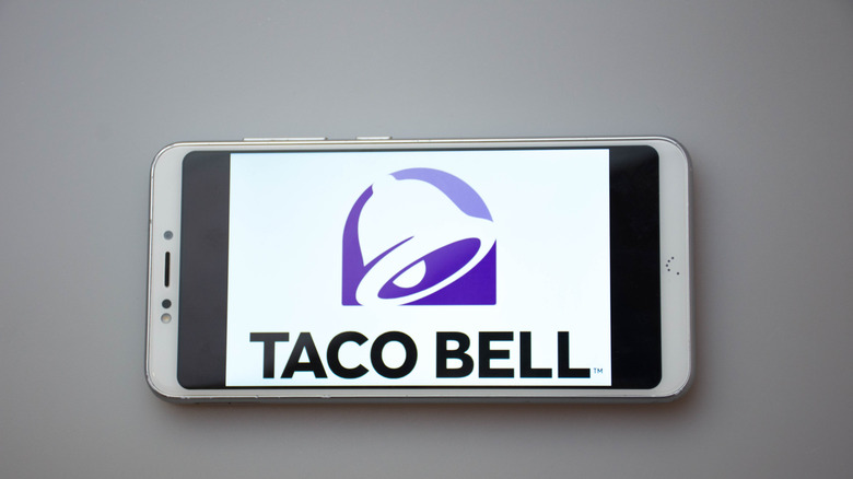 The Taco Bell logo on a phone