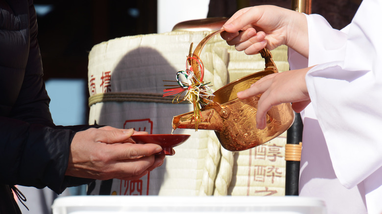 Serving sake in Japanese shrine