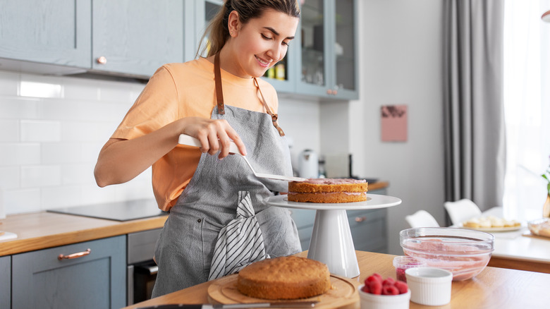 Woman frosting cake