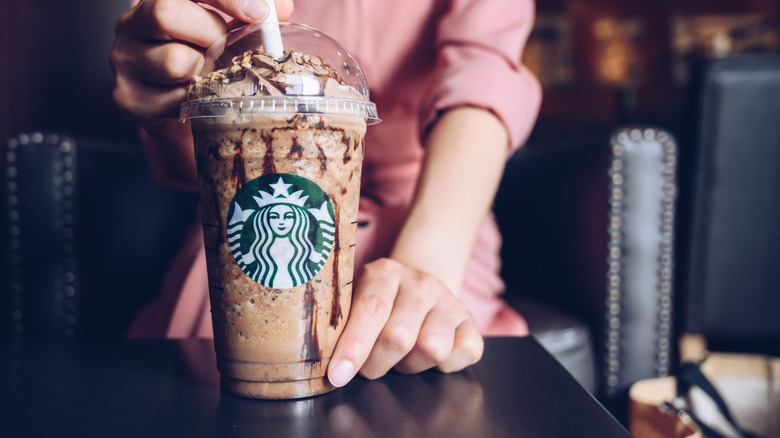 barista presenting Frappuccino