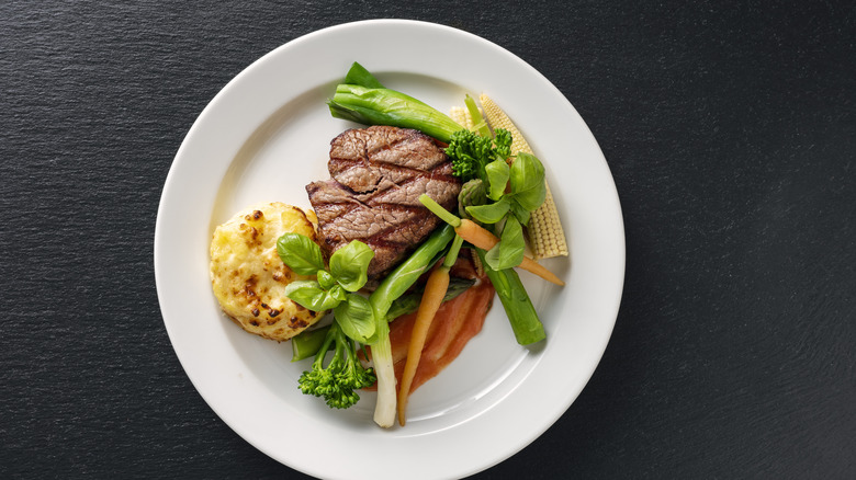 Steak on a plate with colorful veggies