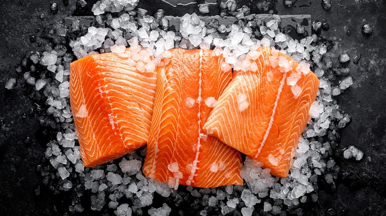 raw salmon pieces over ice 