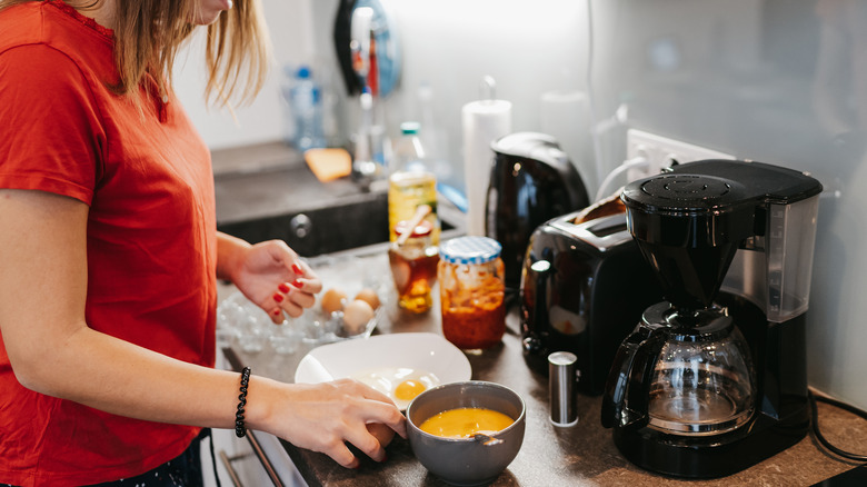 Woman preparing eggs for breakfast