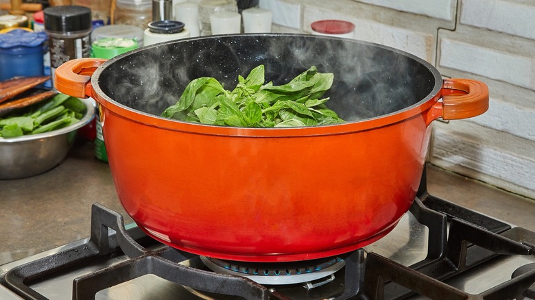 leafy greens in boiling pot