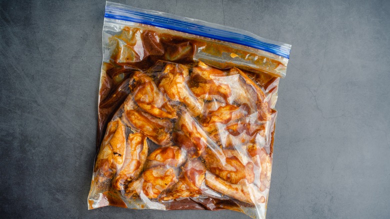 chicken wings marinating in a plastic bag