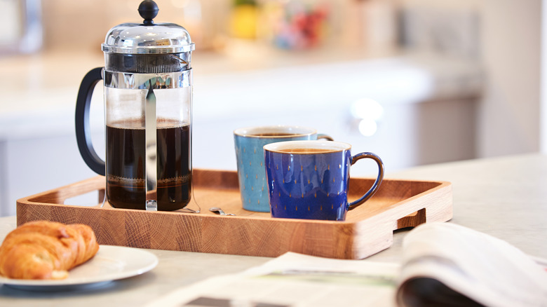 French press with coffee cups