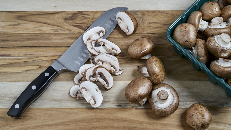 sliced mushrooms on wooden board