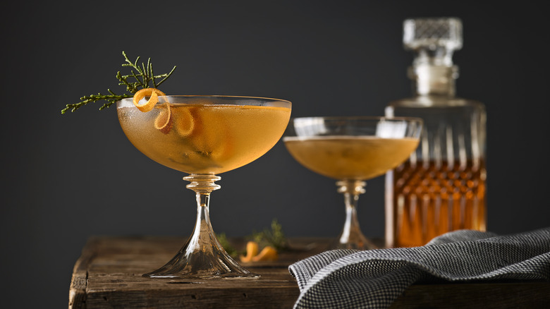 Manhattans in a coupe glass with decanter