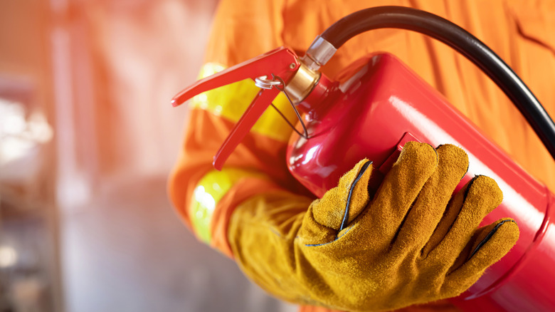 Firefighter holding extinguisher