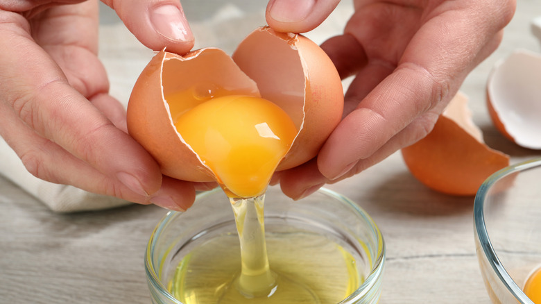 Separating the raw egg yolk from the egg white