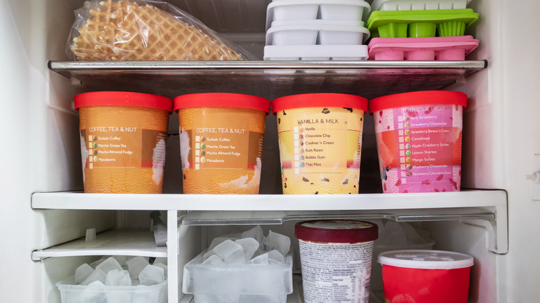 ice cream containers stacked in a freezer