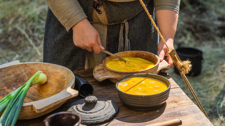 man stirring eggs in a bowl