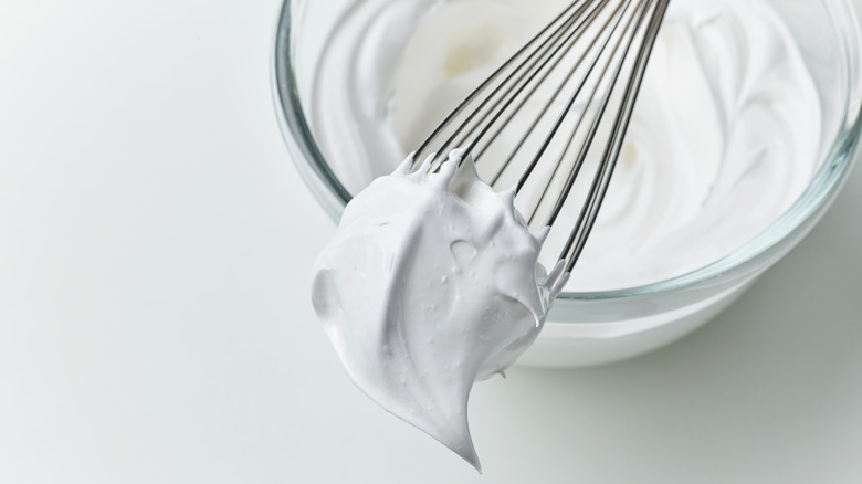 whipped egg whites on whisk