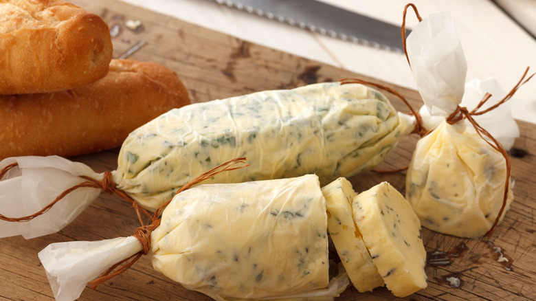 Compound butter rolled in wax paper with baguettes 