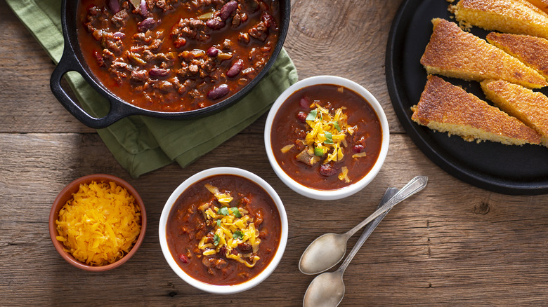 Bowls of hot chili on table