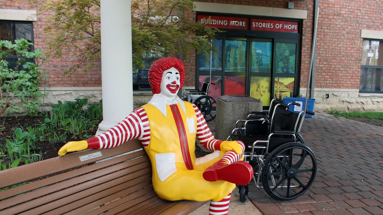Ronald McDonald sitting on bench