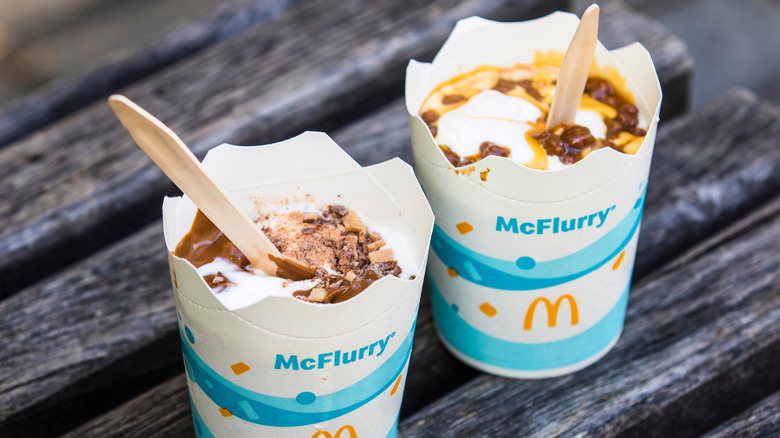 Two lidless McFlurries with wooden spoons