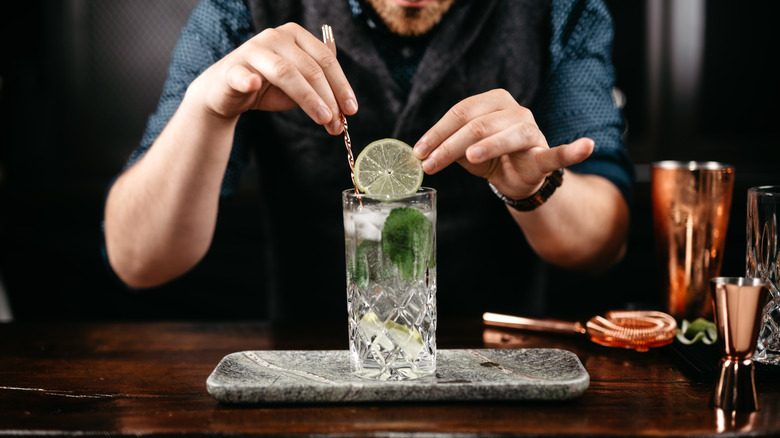 A man preps a cocktail