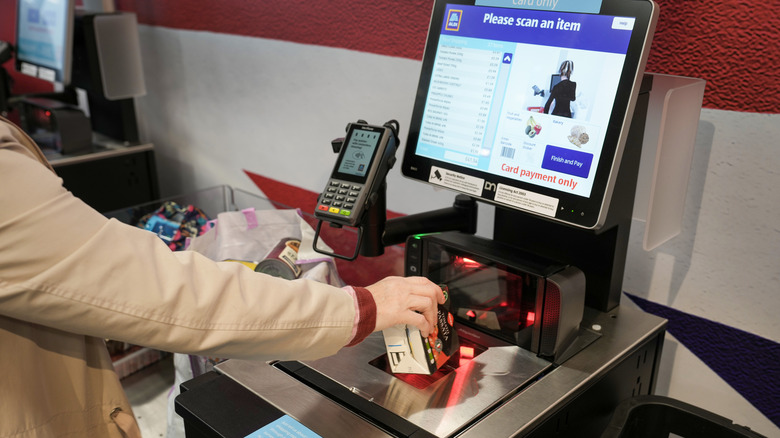 person using the self-checkout at an Aldi supermarket