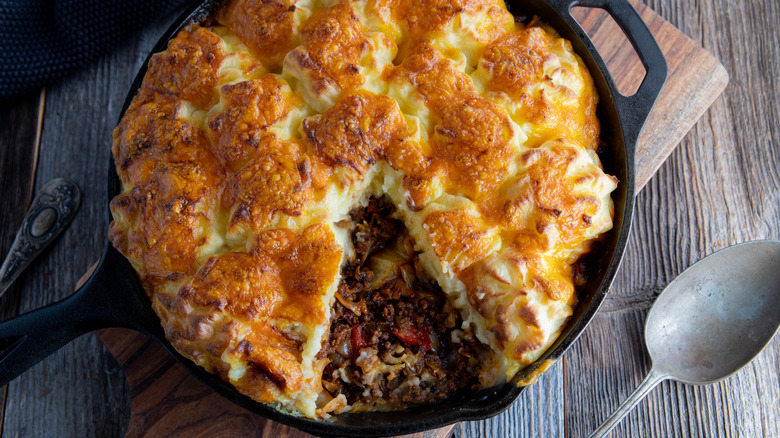 Shepherd's pie in skillet with slice removed