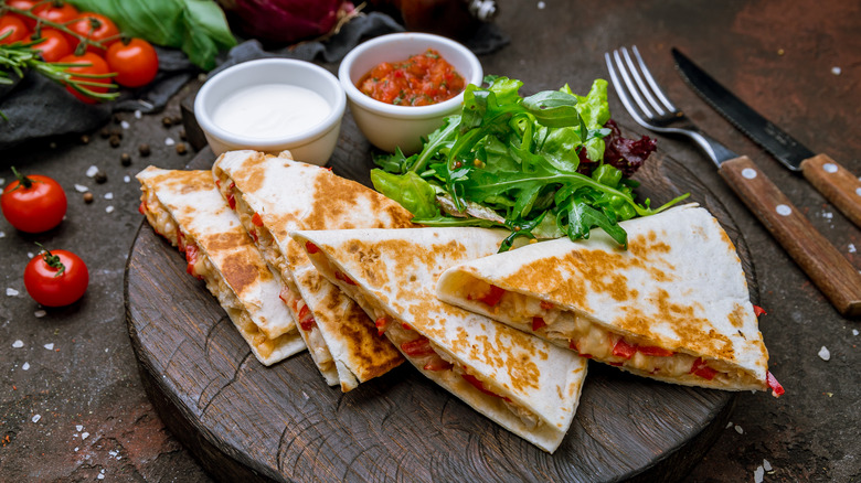 Sliced quesadilla on wooden dish