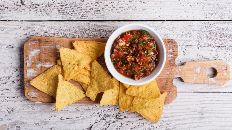 salsa and chips on wooden table