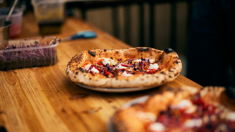 Finished pizza on wooden counter